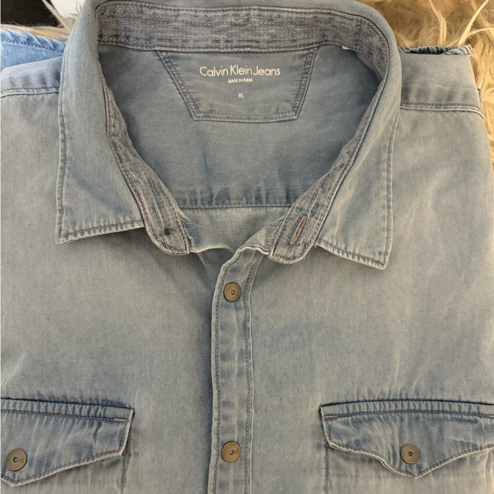 Men’s Calvin Klein short sleeve light denim with snaps.